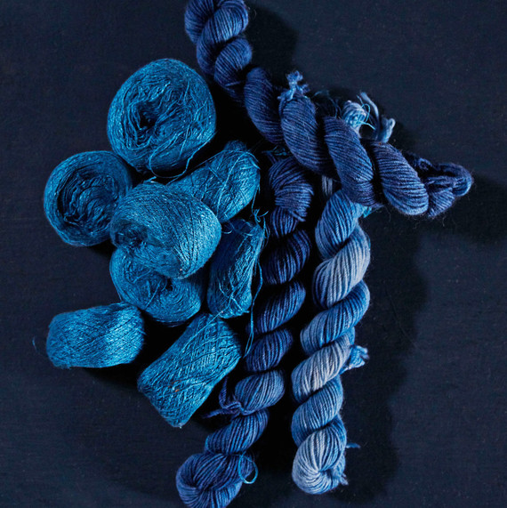 various balls and packages of blue yarn