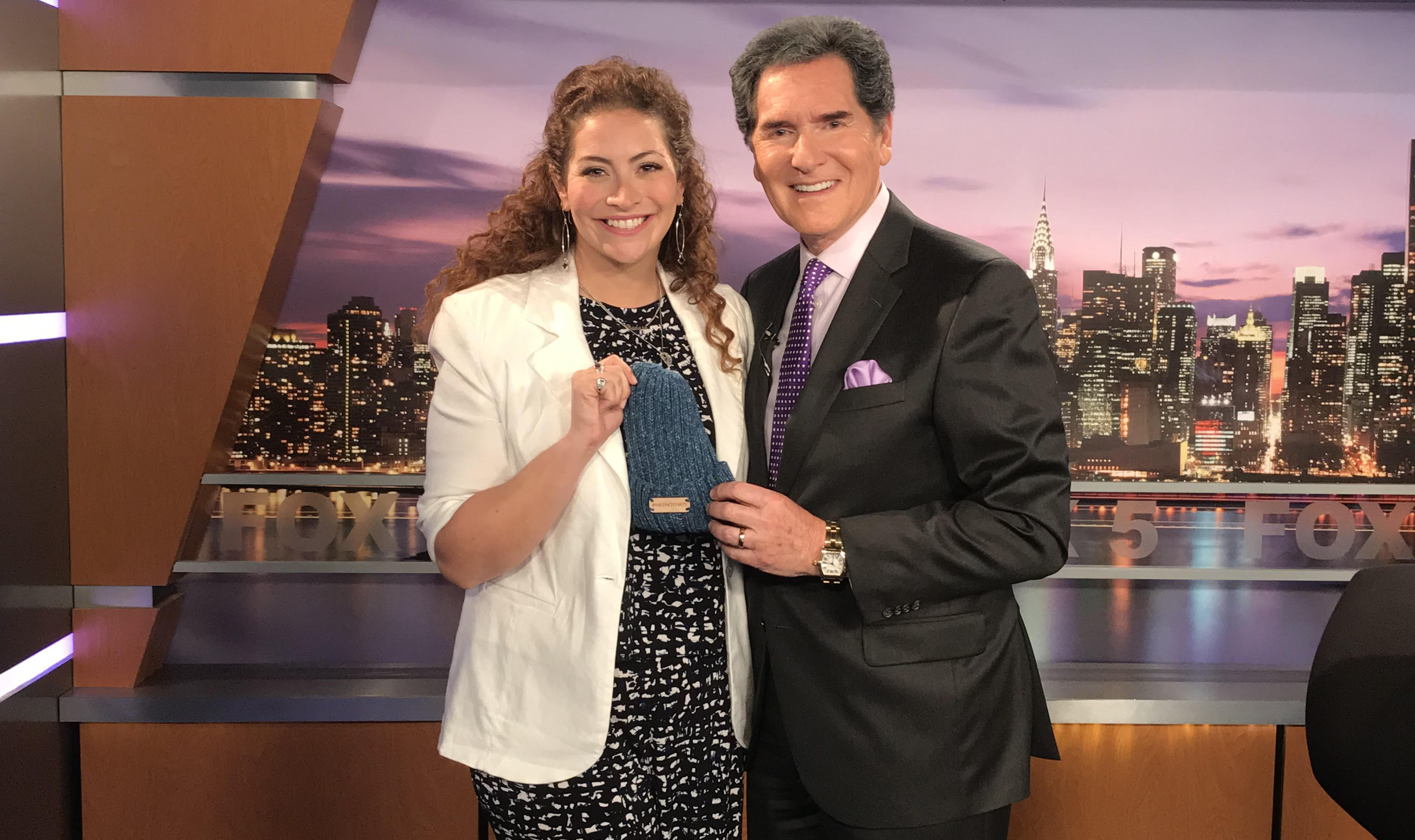 Shira posing with Fox5 news anchor in television studio