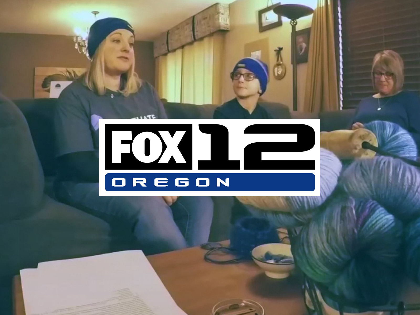 Fox 12 Oregon logo overlaid on image of 2 women and boy knitting hats